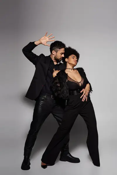 A couple strikes a bold pose, exuding chemistry and confidence in their elegant attire. — Stock Photo