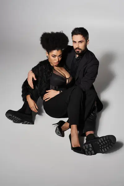A stylish couple shows their love in elegant outfits, posing intimately and confidently. — Stock Photo