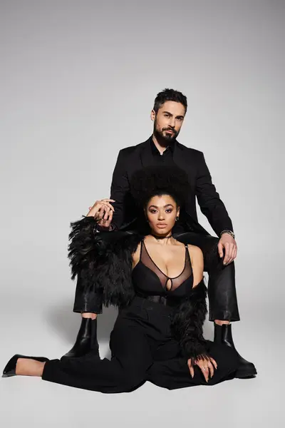 The stylish couple strikes an intimate pose, showcasing love and connection through fashion. — Stock Photo