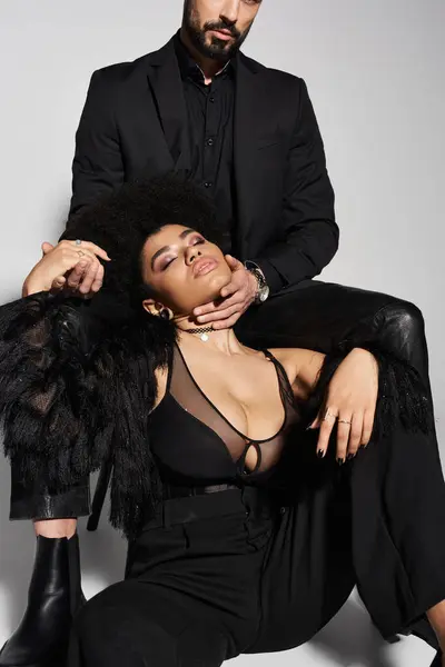 A couple showcases their deep connection and allure in a chic, modern atmosphere. — Stock Photo