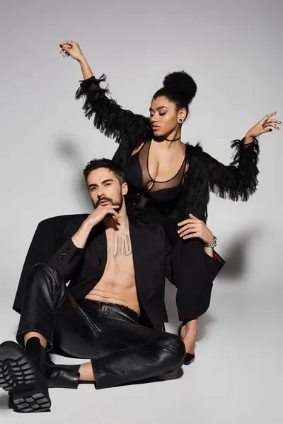 This captivating couple expresses love and confidence through their stunning outfits and poses. — Stock Photo