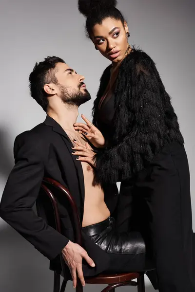 A loving couple showcases their chemistry in elegant outfits, exuding passion and allure. — Stock Photo