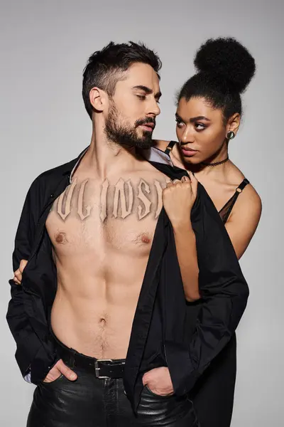 A passionate couple shares a tender moment in a modern studio, exuding love and desire. — Stock Photo