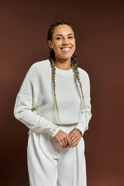 A young woman smiles brightly while dressed warmly for the autumn season in soft, inviting colors. — Stock Photo