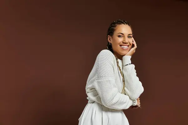 A cheerful young woman smiles brightly, showcasing her autumn outfit with elegance and joy. — Stock Photo