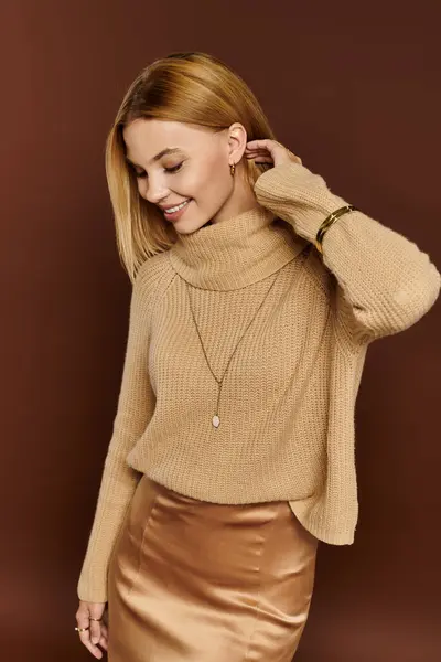 A young woman showcases her autumn style with a chic sweater and silky skirt, radiating warmth. — Stock Photo
