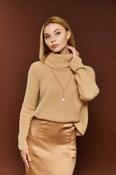 A beautiful young woman displays her autumn attire with confidence amid warm color tones. — Stock Photo