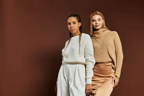 Two young women express their love in stylish autumn outfits, radiating joy and warmth. — Stock Photo