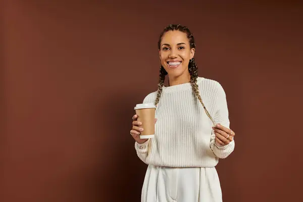 Beautiful women wrapped in warm clothing with cup of coffee in hand. — Stock Photo