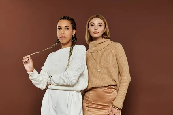 Two women in autumn outfits stand confidently, showcasing their unique styles and connection. — Stock Photo