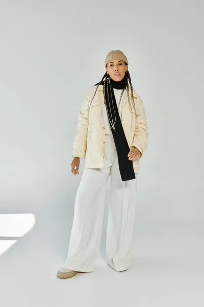 Trendy african american woman in autumn stylish attire on white backdrop. — Stock Photo