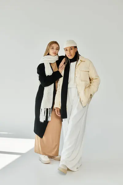 A young couple shares an intimate moment, wearing cozy autumn outfits in soft tones, evoking warmth. — Stock Photo
