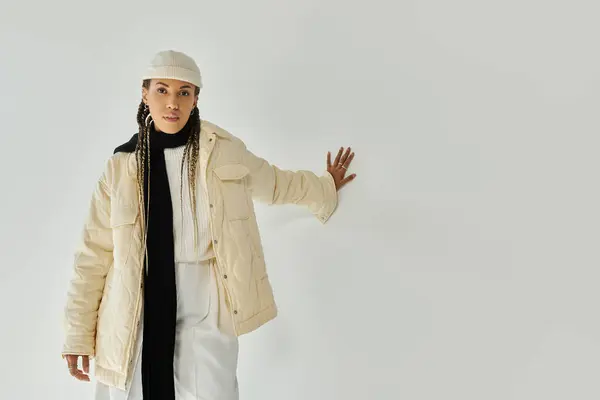Good looking young woman in stylish warm attire posing on white backdrop. — Stock Photo