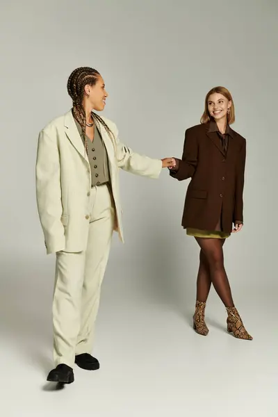 Two young women enjoy a cozy autumn day, dressed in stylish outfits full of warmth and charm. — Stock Photo