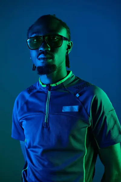 A young African American man showcases his unique style in an artistic studio setting under neon lights. — Stock Photo