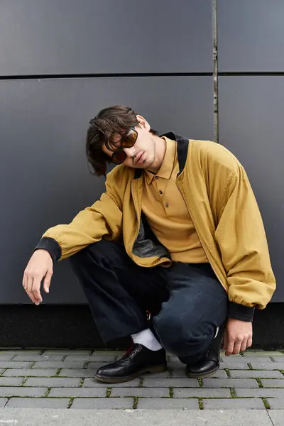 A young man showcases his fashion sense in an autumn ensemble while posing confidently outdoors. — Stock Photo