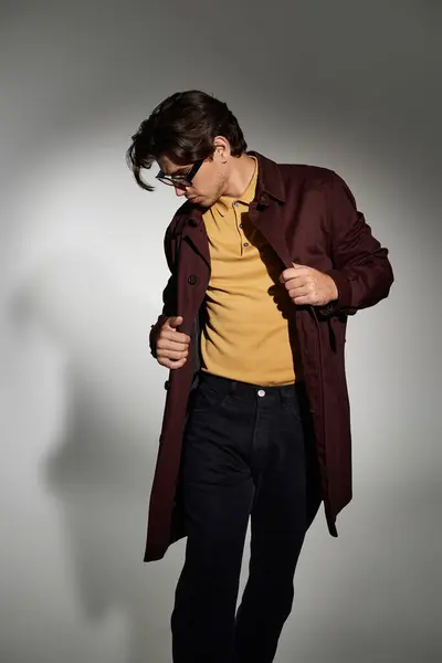 A stylish young man poses confidently in a fashionable autumn look, highlighting his modern outfit choice. — Stock Photo