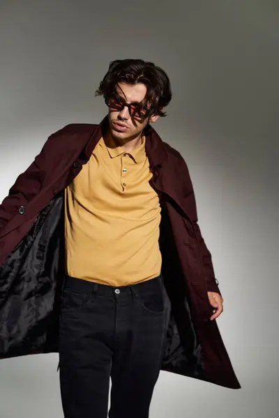 A young, handsome man poses in a stylish autumn outfit, radiating confidence and modern fashion sensibility. — Stock Photo