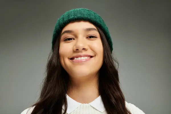 A young woman shines in a stylish green beanie, radiating happiness and depth. — Stock Photo