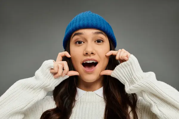 A young woman beams with excitement, dressed stylishly in cozy winter attire, radiating joy. — Stock Photo