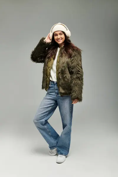 A young woman in stylish winter wear stands confidently, exuding warmth and emotion. — Stock Photo