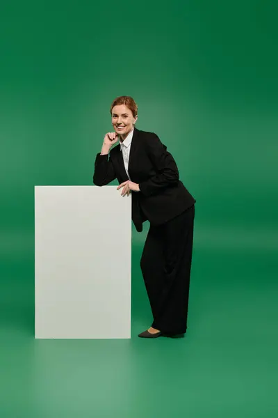 A stylish TV presenter poses gracefully in a professional outfit — Stock Photo