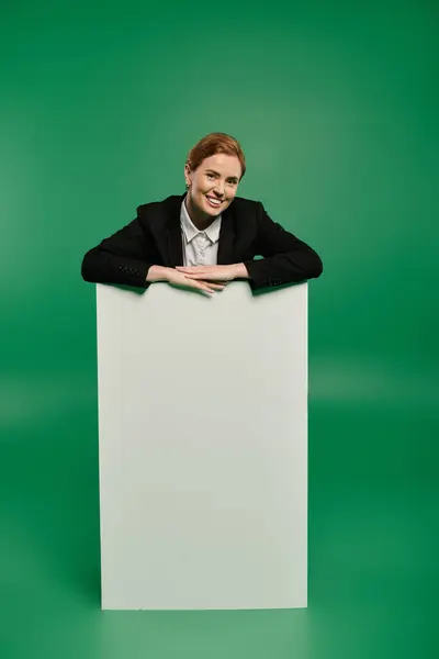 A talented TV presenter in formal black clothing smiles warmly — Stock Photo