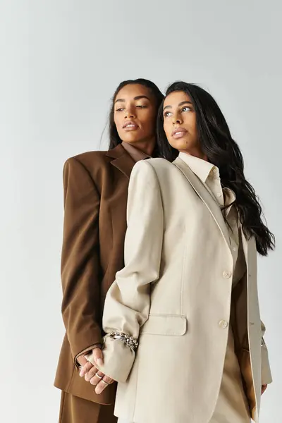 Two fashionable young women pose confidently together, highlighting their unique styles. — Stock Photo