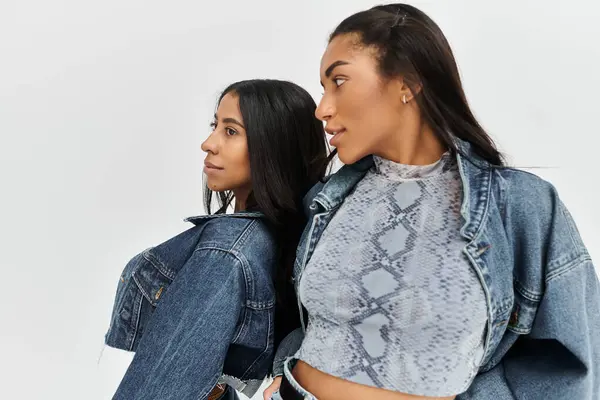 Two young women showcase their trendy denim fashion, highlighting individual styles and confidence. — Stock Photo