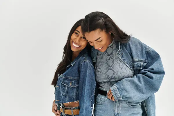 Friends express happiness and confidence in trendy outfits, embracing each other warmly. — Stock Photo