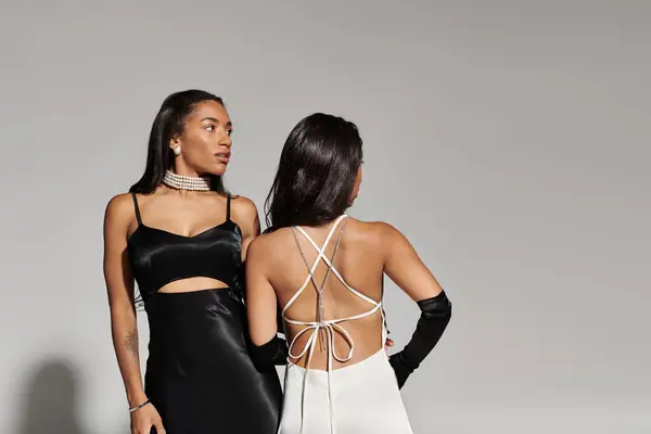 Two young women showcase their fashion sense while holding hands, radiating joy and confidence. — Stock Photo
