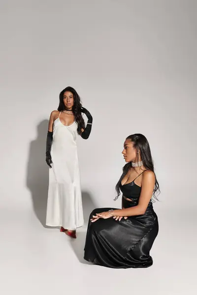 Two young women exude confidence and elegance while posing in fashionable outfits. — Stock Photo
