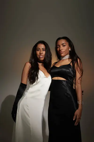 Two fashionable individuals stand back to back, showcasing their unique styles and poise. — Stock Photo