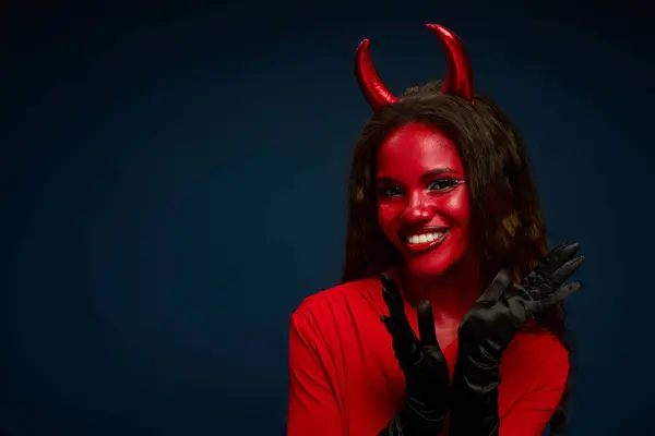 The beautiful woman dressed as a devil joyfully expresses excitement for Halloween festivities. — Stock Photo