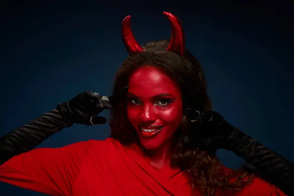 A joyful woman in a striking devil costume showcases her creativity and spirit. — Stock Photo