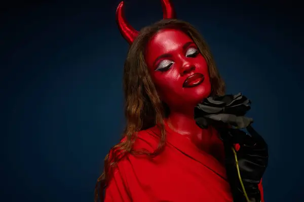A radiant woman in a striking Halloween outfit poses confidently, blending beauty and creativity. — Stock Photo