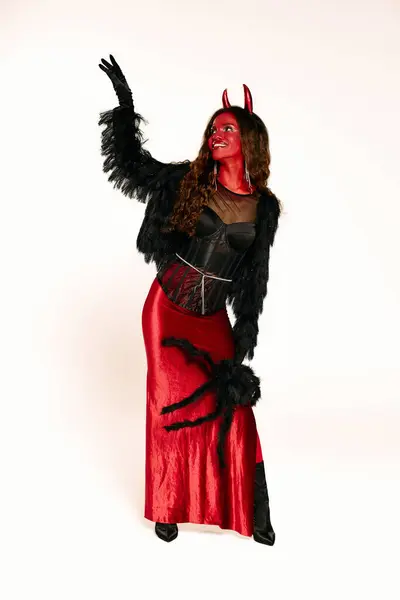 The woman embraces the Halloween festivities in her vibrant red outfit, radiating confidence. — Stock Photo