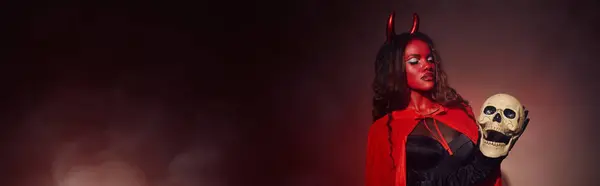 Feeling the Halloween spirit, a captivating woman in a devilish costume showcases her eerie charm. — Stock Photo