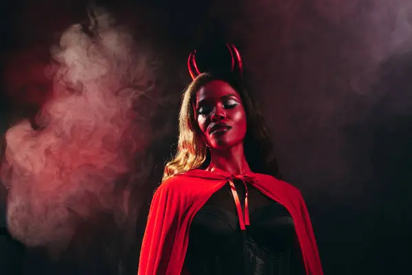 A captivating woman showcases her elegant devil costume, perfectly suited for Halloween festivities. — Stock Photo