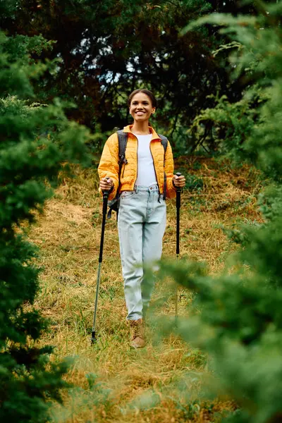 A young woman enjoys her hike in a lush autumn forest filled with colorful foliage and natural beauty. — Stock Photo