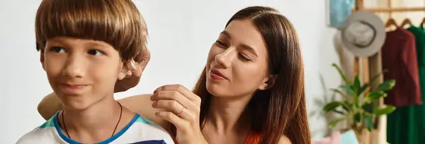A caring mother helps her little boy with hearing impairment in a warm and inviting space. — Stock Photo