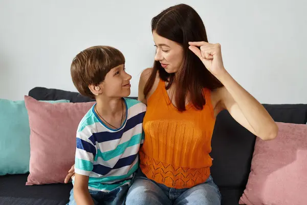 A caring mother engages her hearing impaired son in a delightful learning activity together. — Stock Photo