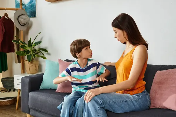 A mother engages attentively with her son, fostering communication and understanding. — Stock Photo