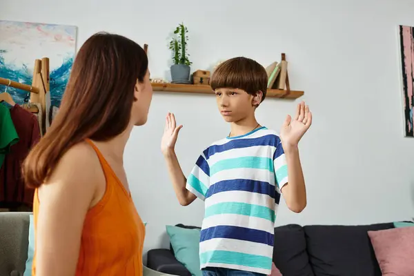 A dedicated mother engages with her son, fostering connection despite hearing challenges. — Stock Photo