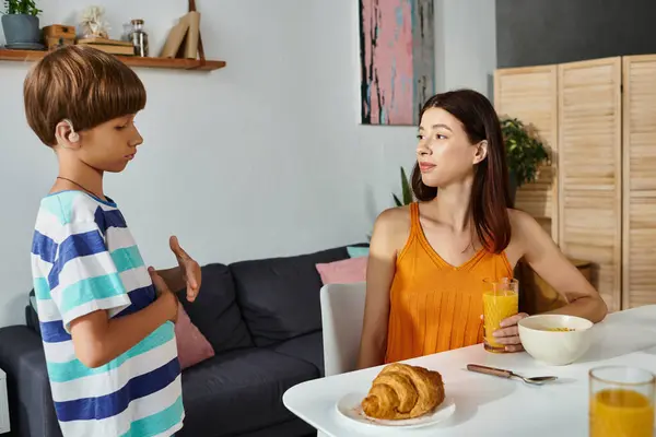 A mother and her son share a meaningful discussion over breakfast in their cozy kitchen. — Stock Photo