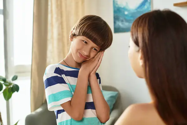 A young boy with hearing impairment shares a warm and joyful interaction with his loving mom. — Stock Photo