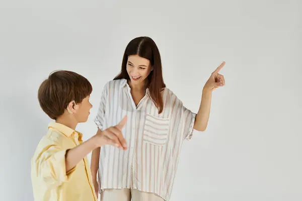 A joyful interaction unfolds as a mother and her son share a moment of connection and learning. — Stock Photo