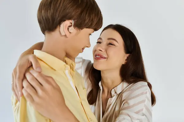A mother joyfully embraces her hearing impaired son in a heartwarming moment. — Stock Photo