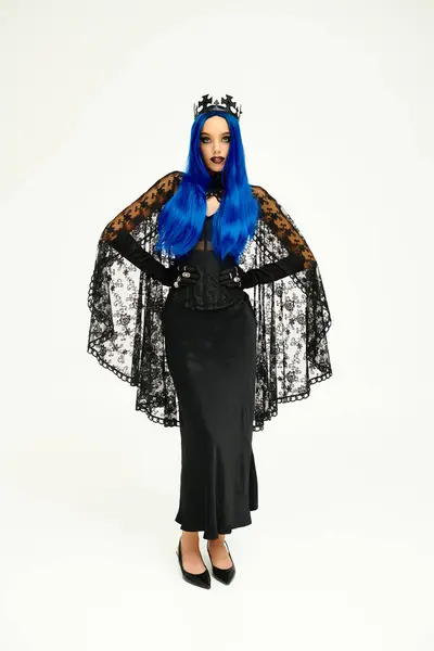 A young woman with vibrant blue hair showcases her unique Halloween costume, exuding elegance. — Stock Photo