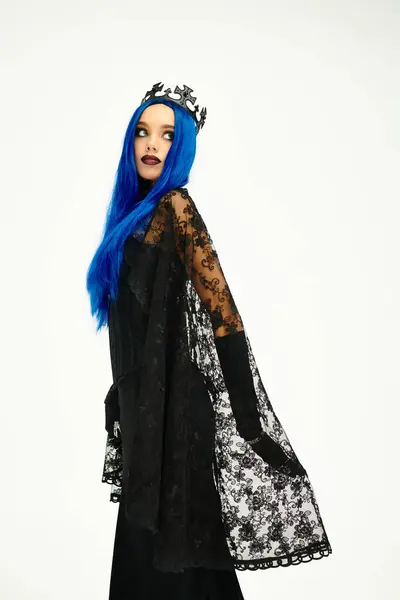 In a stunning Halloween outfit, the woman radiates mystique with her blue hair and dark look. — Stock Photo